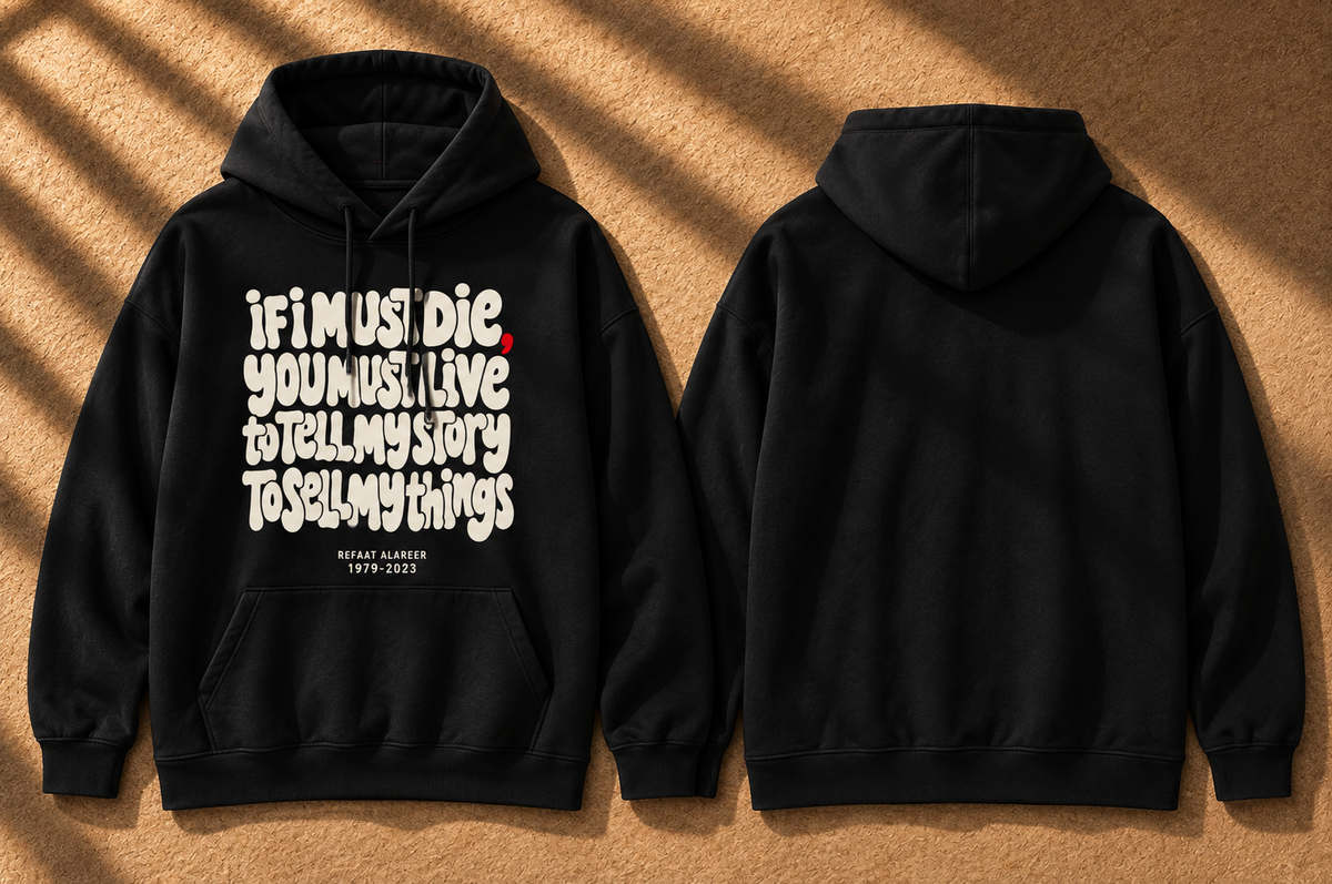 2 black hoodies on the floor with part of poem from poet from Gaza If I must Die, you must live. back is blank