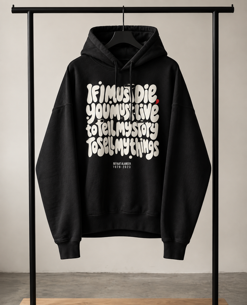 black hoodie on a rack with part of poem from poet from Gaza If I must Die, you must live