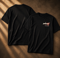 Two black short-sleeve T-shirts laid flat on a textured brown surface with warm directional shadows. The back view is shown on the left, and the front view is shown on the right, featuring a small chest graphic with a rifle illustration and text.