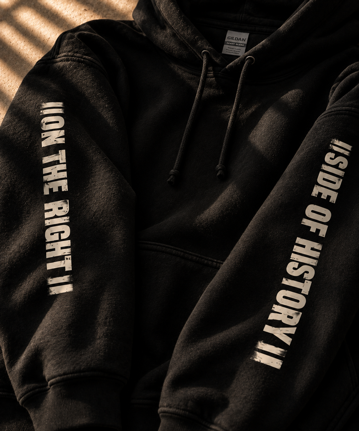 Closeup of Black hoodie , right sleeve reads "On the right" left sleeve reads "side of history".