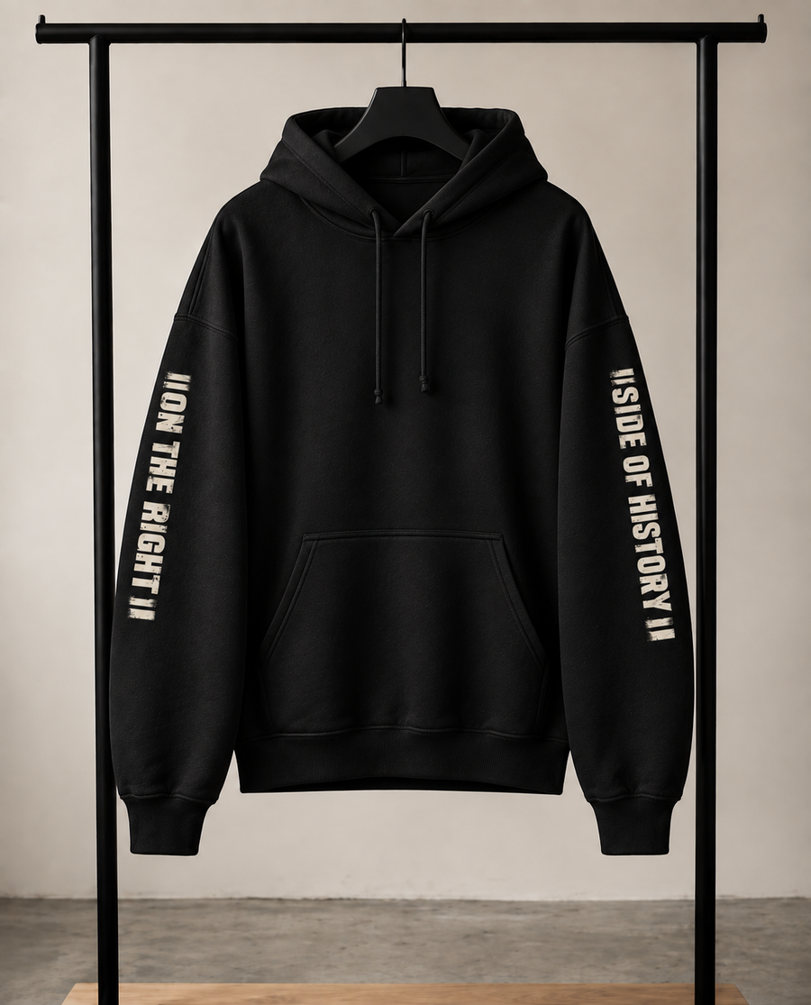 Black hoodie hanging on a rack, right sleeve reads "On the right" left sleeve reads "side of history".