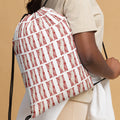 woman carrying a drawstring back with the Palestinian map pattern in tatter embroidery style